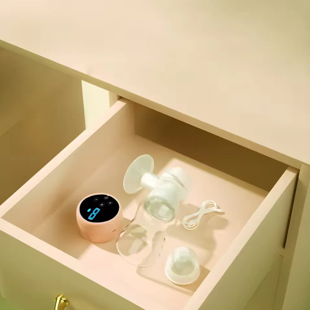 Breast pump and accessories in a drawer with a warm light