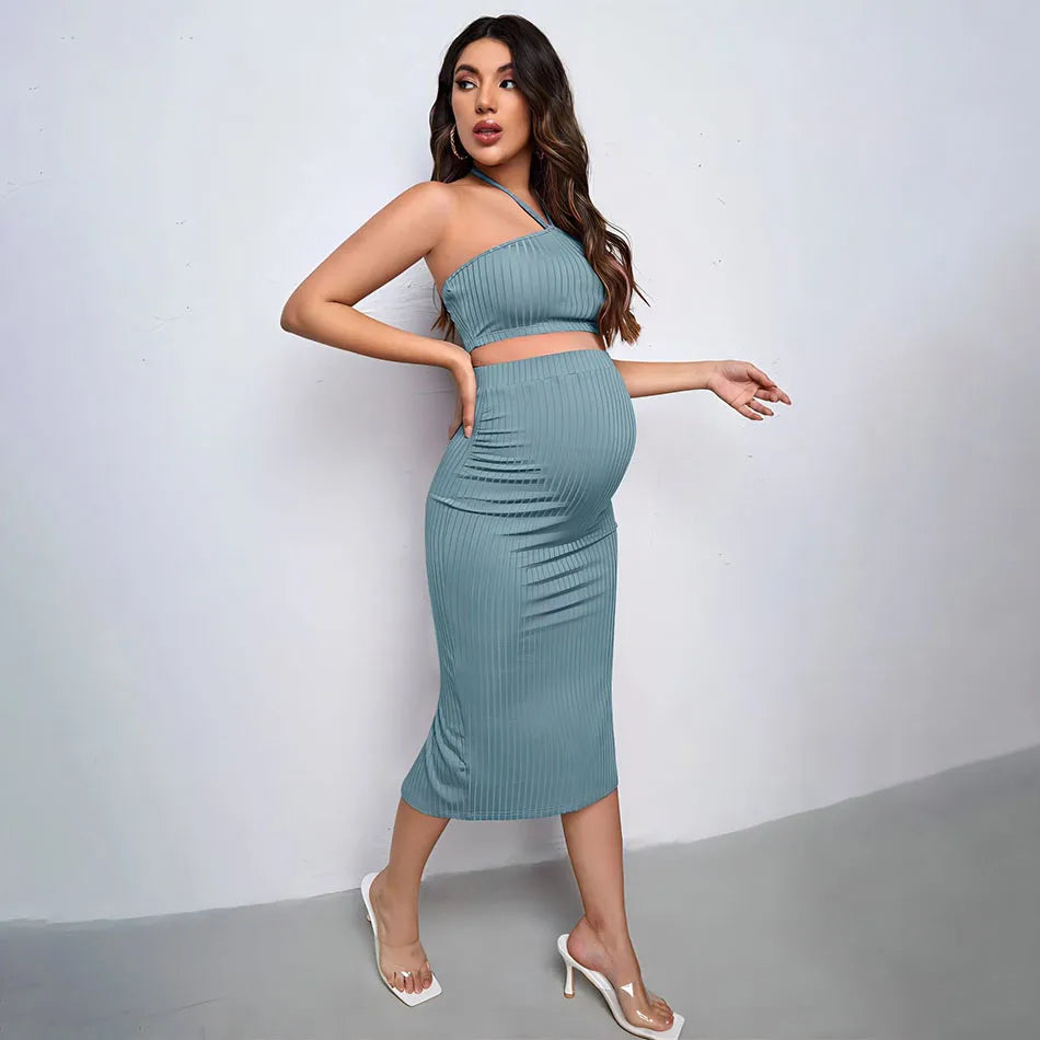 Woman wearing a teal ribbed dress against a white background