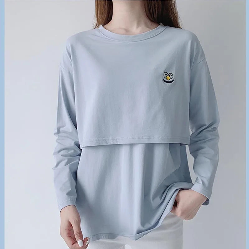 Light blue long-sleeve shirt with a small logo on a plain background